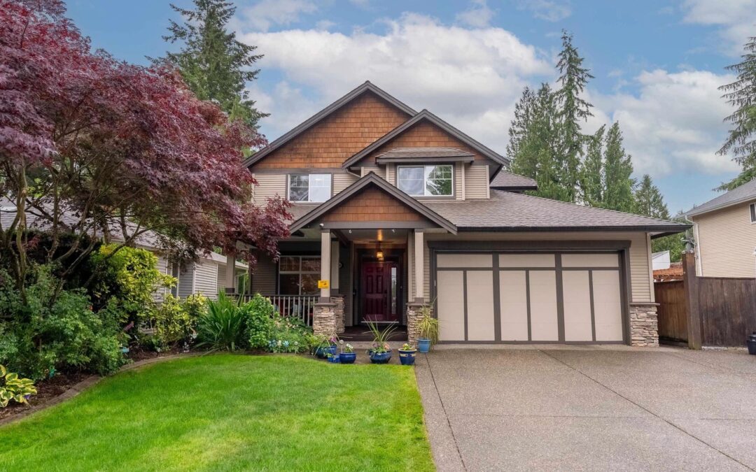 A luxurious home in Abbotsford featuring a spacious driveway and an elegant garage.