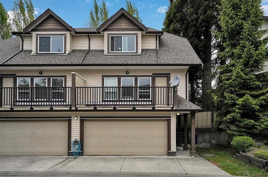 Front view of a two-story home featuring garages and a balcony, representing trusted local mortgage brokers.