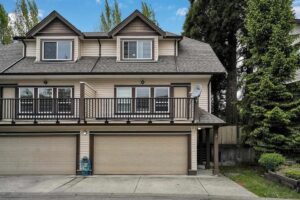 Front view of a two-story home featuring garages and a balcony, representing trusted local mortgage brokers.