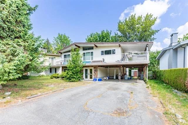 A charming home featuring a driveway and garage, ideal for potential buyers in North Vancouver's real estate market.