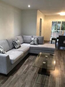 A luxurious living room in Abbotsford featuring a stylish couch and an elegant coffee table.